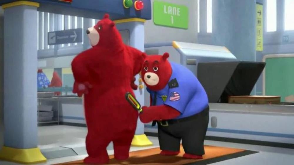 A screenshot from a Charmin toilet paper commercial, where one bear is having their bare ass inspected for lingering bits of toilet paper by the Charmin equivalent of a TSA agent