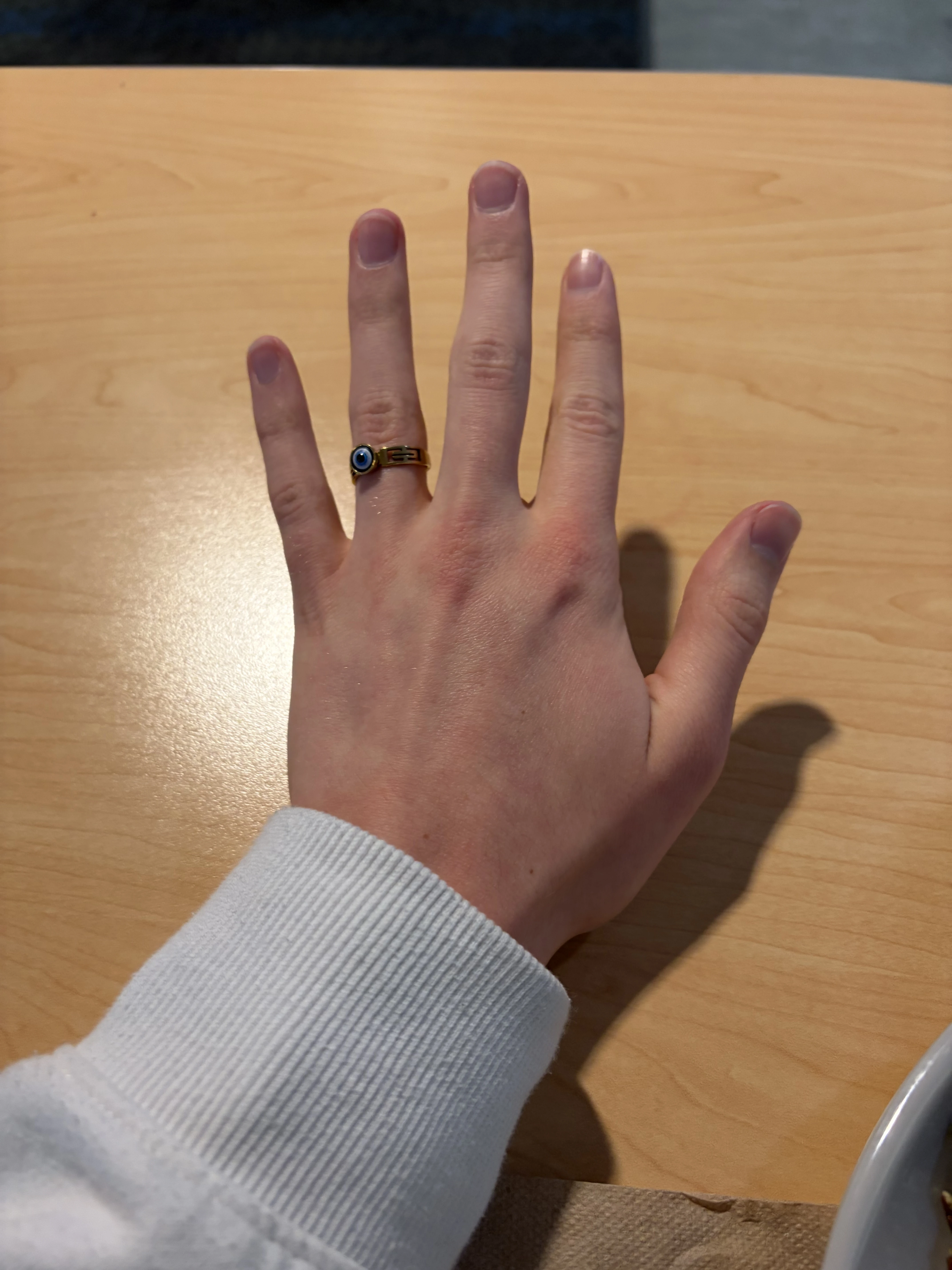 a cute girl’s hand that very much sticks out of her sleeve